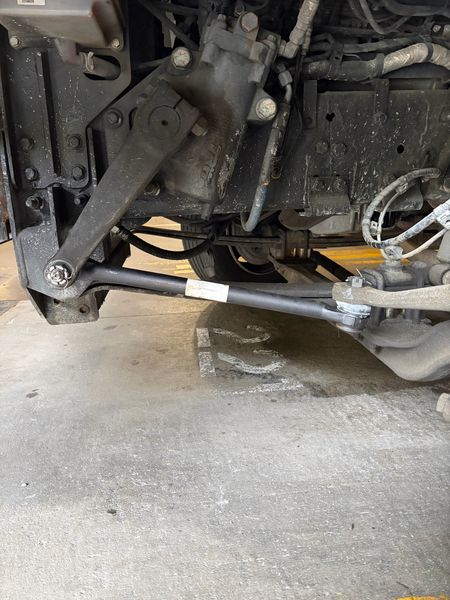 New drag link installed under a truck at the steering gear box